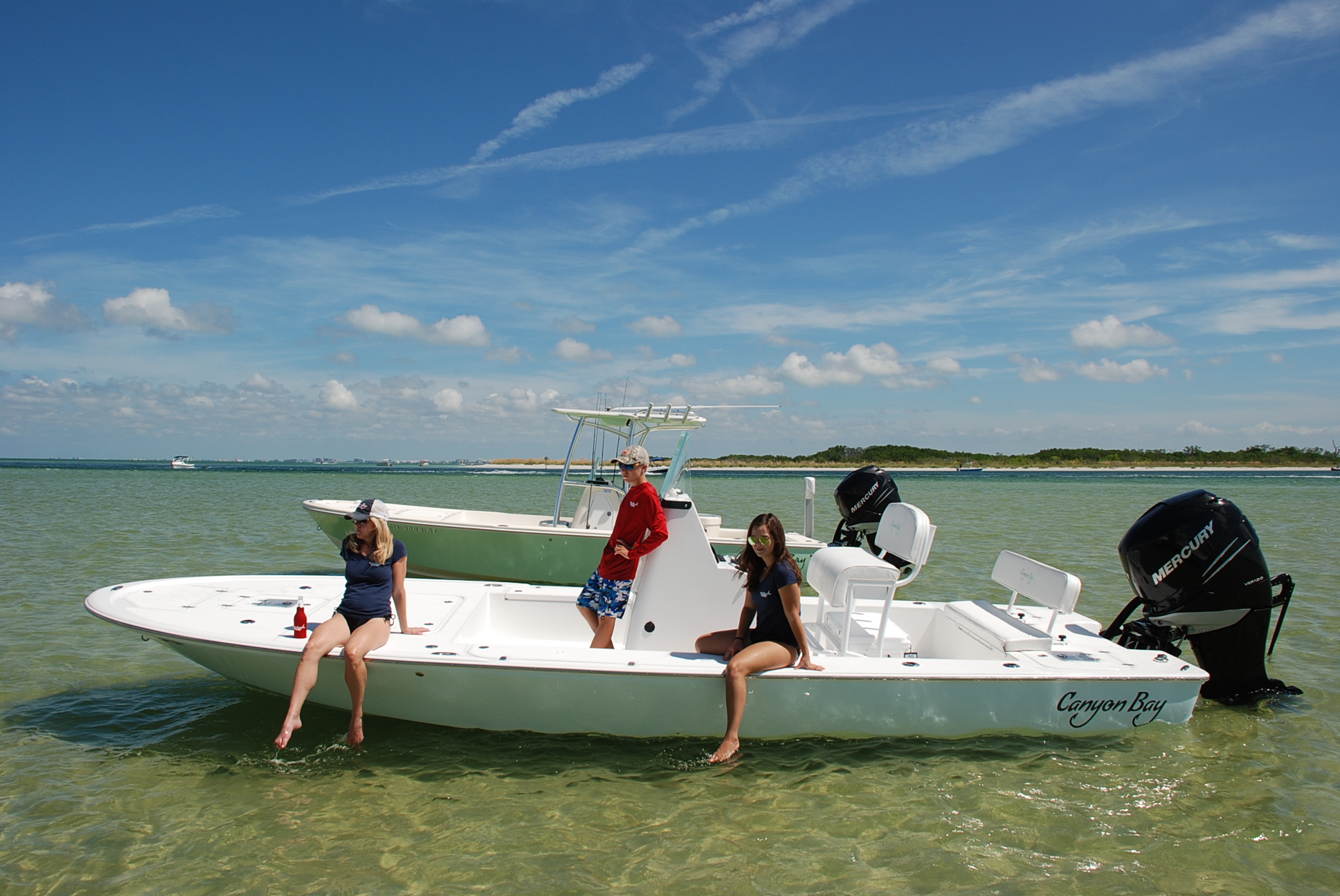 Family relaxing on a Canyon Bay 24B at the sandbar