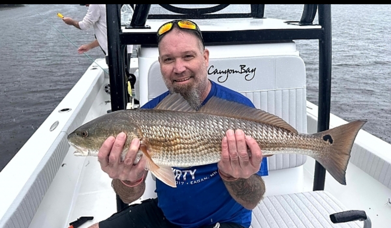Canyon Bay angler big redfish inshore fishing
